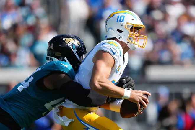 JACKSONVILLE, FLORIDA - NOVEMBER 16: Travon Walker #44 of the Jacksonville Jaguars sacks Justin Herbert #10 of the Los Angeles Chargers during the first quarter at EverBank Stadium on November 16, 2025 in Jacksonville, Florida. (Photo by Rich Storry/Getty Images)