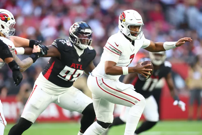 Dec 21, 2025; Glendale, Arizona, USA; Arizona Cardinals quarterback Jacoby Brissett (7) is pressured by. Atlanta Falcons defensive tackle Ruke Orhorhoro (98) during the first half at State Farm Stadium. Mandatory Credit: Mark J. Rebilas-Imagn Images