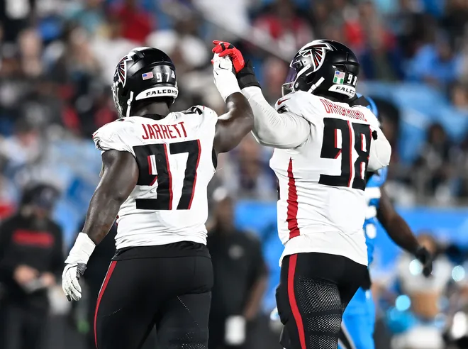 CHARLOTTE, NORTH CAROLINA - OCTOBER 13: Grady Jarrett #97 and Ruke Orhorhoro #98 of the Atlanta Falcons celebrate a defensive play against the Carolina Panthers during the fourth quarter at Bank of America Stadium on October 13, 2024 in Charlotte, North Carolina. (Photo by Matt Kelley/Getty Images)