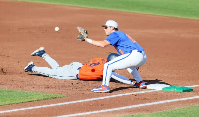 Auburn infielder Eric Guevara (8) beats throw back to first durning and NCAA baseball game at Condron Family Ballparkin Gainesville, FL on Friday, April 17, 2026. [Alan Youngblood/Gainesville Sun]