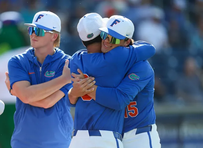 Florida pitcher Christian Rodriguez (8) and Florida pitcher Joshua Whritenour (15) along with the rest of the get ready to play before an NCAA baseball game at Condron Family Ballparkin Gainesville, FL on Friday, April 17, 2026. [Alan Youngblood/Gainesville Sun]