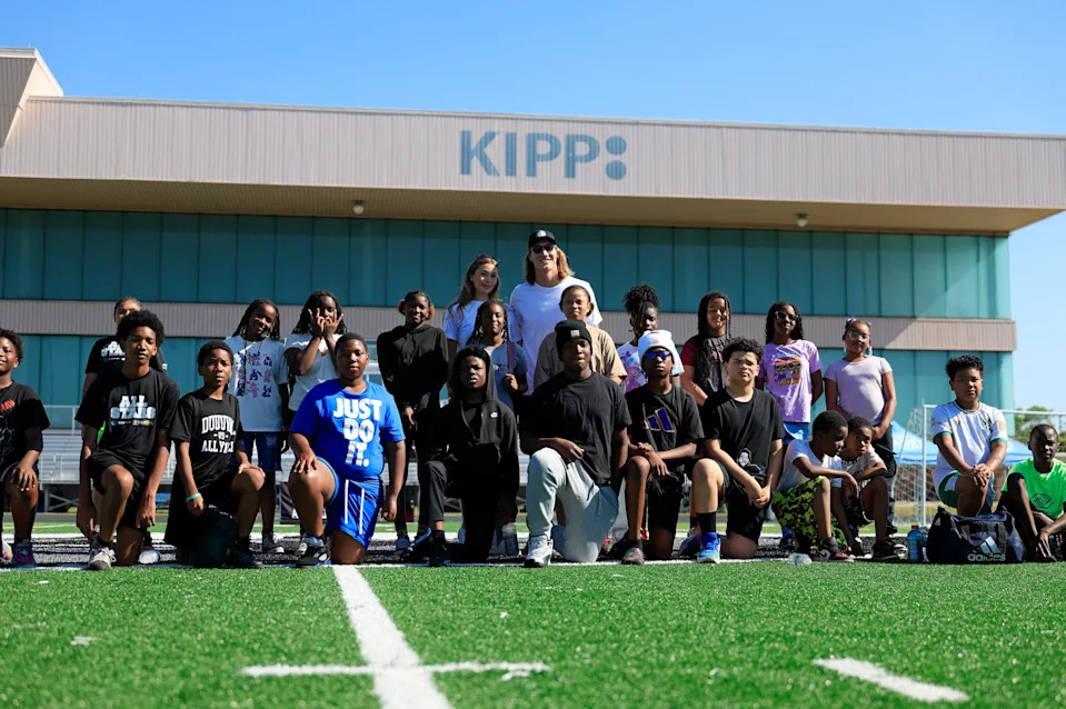 Jacksonville Jaguars quarterback Trevor Lawrence and wife Marissa Lawrence take a group photo during a a joint football-soccer camp at KIPP Bold City High School, Saturday, April 25, 2026, in Jacksonville, Fla. The two hosted the one-and-a-half-hour youth sports camp.