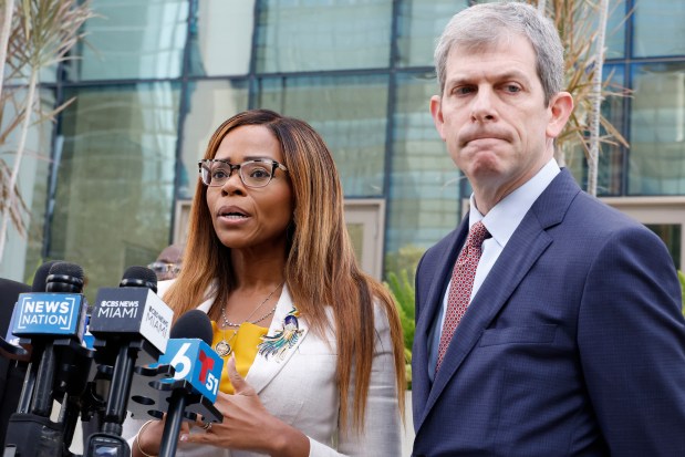 U.S. Rep. Sheila Cherfilus-McCormick, D-Fla., left, speaks to the media as her lawyer David Markus looks on after a hearing in federal court Monday, Dec. 29, 2025 in Miami. (AP Photo/Terry Renna)