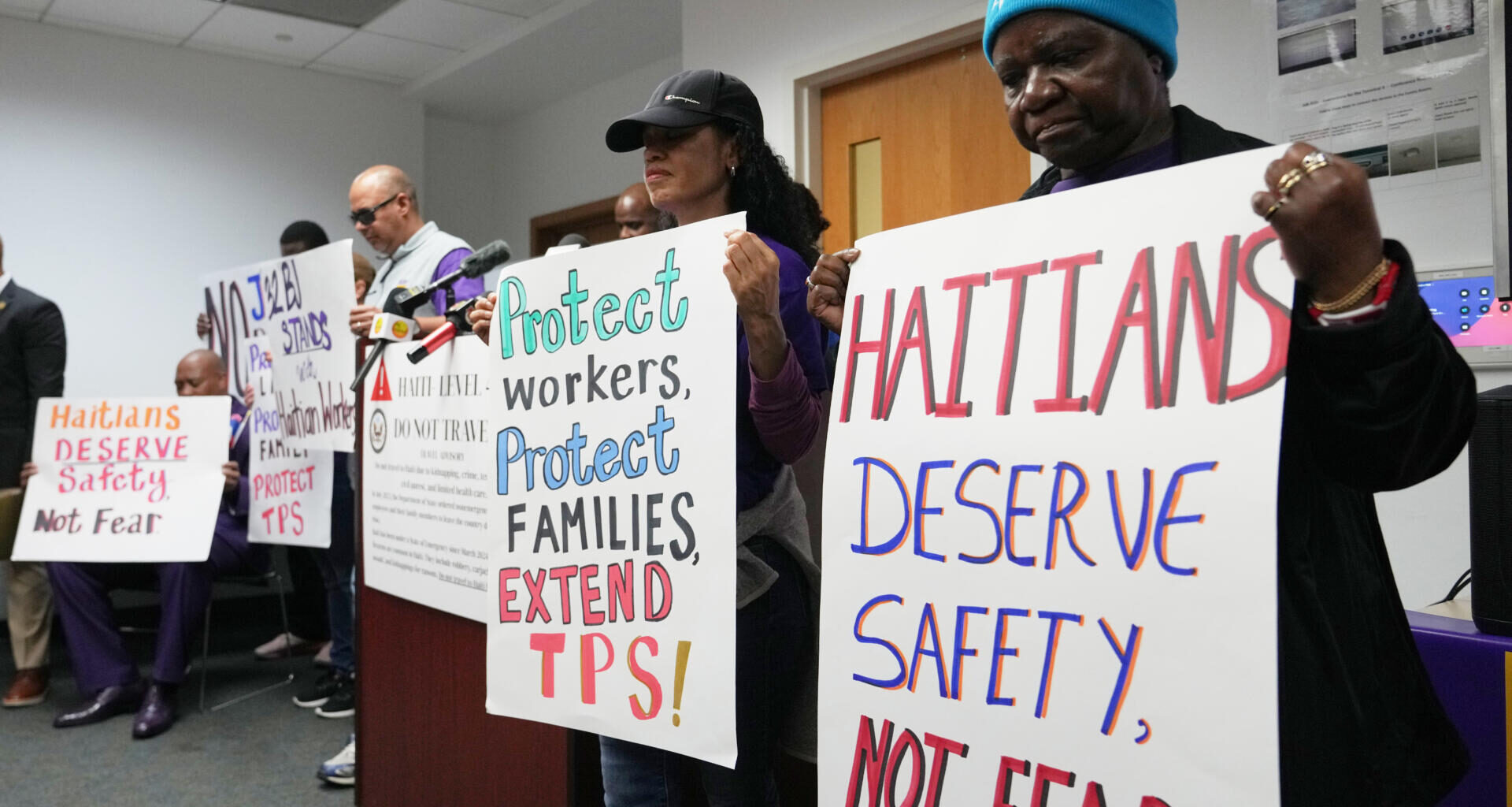 People hold signs during a rally in support of the extension of Temporary Protected Status (TPS) for Haitian immigrants before it expires on February 3, Wednesday, Jan. 28, 2026, in Fort Lauderdale, Fla. (Lynne Sladky/AP)