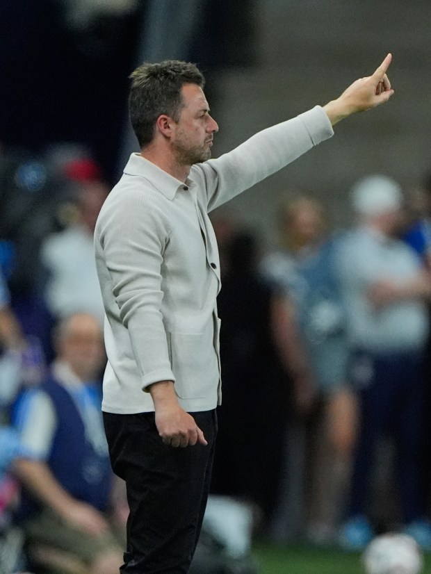 Colorado Rapids manager Matt Wells motions to his team during the first half of an MLS soccer match against Sporting Kansas City, Saturday, March 21, 2026, in Kansas City, Kan. (AP Photo/Charlie Riedel)
