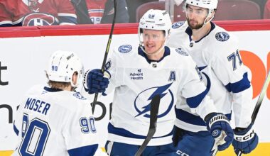 Tampa Bay Lightning's Jake Guentzel (59) celebrates with teammates J.J. Moser (90) and Anthony Cirelli (71) after scoring against the Montreal Canadiens during the second period of Game 4 in a first-round NHL hockey Stanley Cup playoff series in Montreal, Sunday, April 26, 2026. (Graham Hughes/The Canadian Press via AP)
