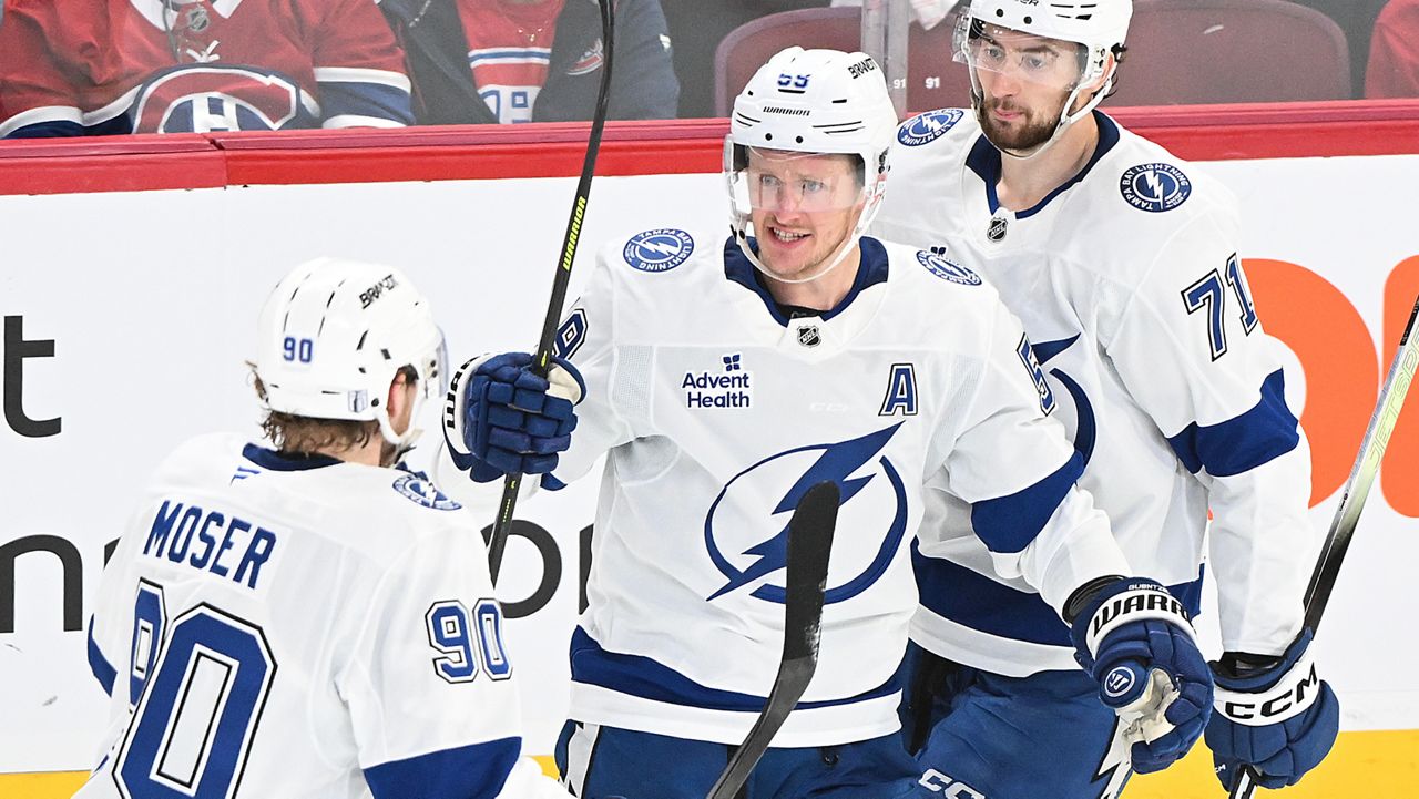 Tampa Bay Lightning's Jake Guentzel (59) celebrates with teammates J.J. Moser (90) and Anthony Cirelli (71) after scoring against the Montreal Canadiens during the second period of Game 4 in a first-round NHL hockey Stanley Cup playoff series in Montreal, Sunday, April 26, 2026. (Graham Hughes/The Canadian Press via AP)