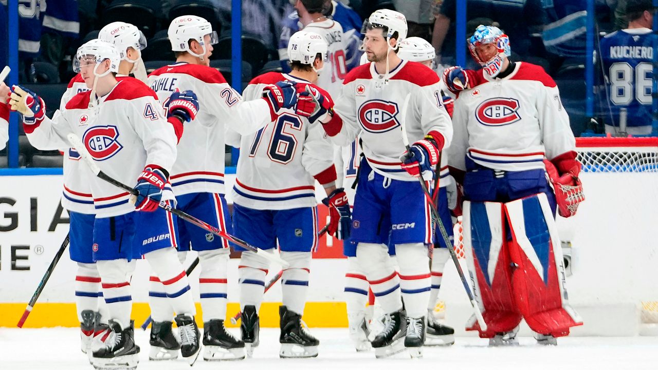 Montreal Canadiens players celebrate their win over the Tampa Bay Lightning in Game 5 of an NHL hockey Stanley Cup first-round playoff series, Wednesday, April 29, 2026, in Tampa, Fla. (AP Photo/Chris O'Meara)