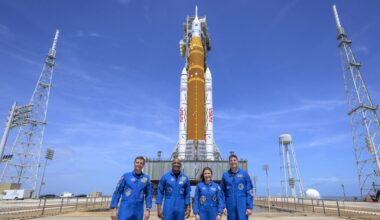 photo of the crew of Artemis II standing in front of its rocket in front of blue skies