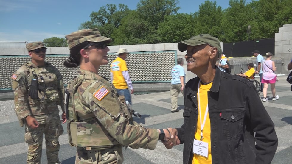 A current member of the U.S. Military shakes the hand of Vietnam Veteran Howard McMillan at...