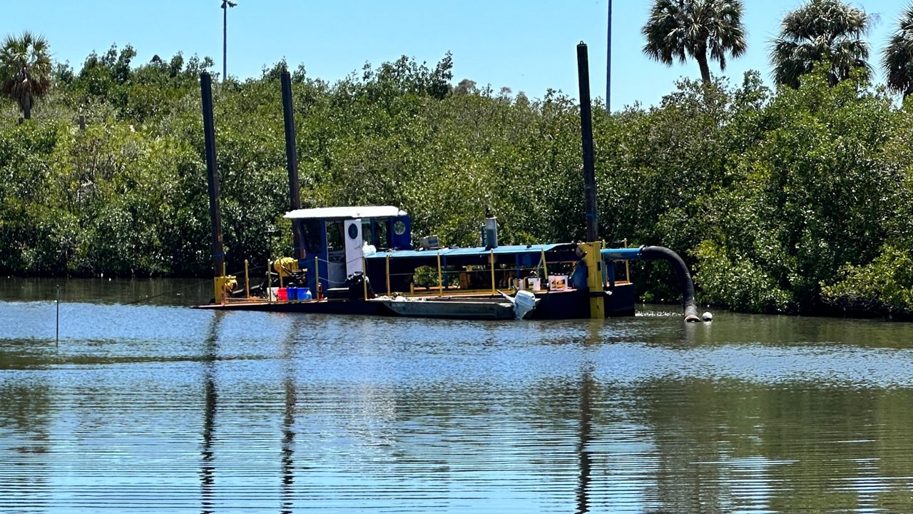 A dredger began pulling sediment from the bottom of Bartlett Lake in St. Petersburg last Thursday to create more storage volume for floodwater. (Spectrum News/Josh Rojas)