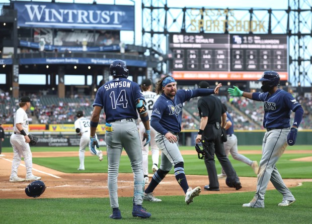Tampa Bay Rays right fielder Ryan Vilade celebrates with his teammates after scoring on a throwing error by Chicago White Sox starting pitcher Noah Schultz in the first inning of a game at Rate Field in Chicago on April 14, 2026. (Chris Sweda/Chicago Tribune)