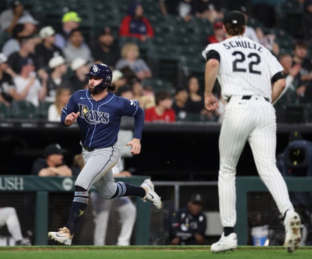 Tampa Bay Rays right fielder Ryan Vilade runs past Chicago White Sox starting pitcher Noah Schultz (22) as he scores on a double by Rays second baseman Ben Williamson in the third inning of a game at Rate Field in Chicago on April 14, 2026. (Chris Sweda/Chicago Tribune)