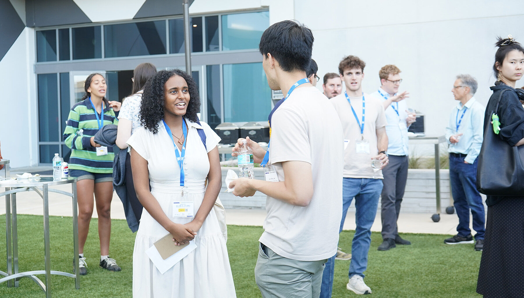 A female attendee speaks with a male attendee outside during the ACC Meeting of the Minds conference