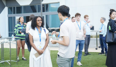 A female attendee speaks with a male attendee outside during the ACC Meeting of the Minds conference
