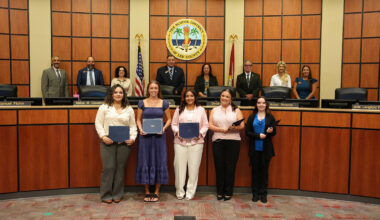 Photo of scholarship recipients with school board members