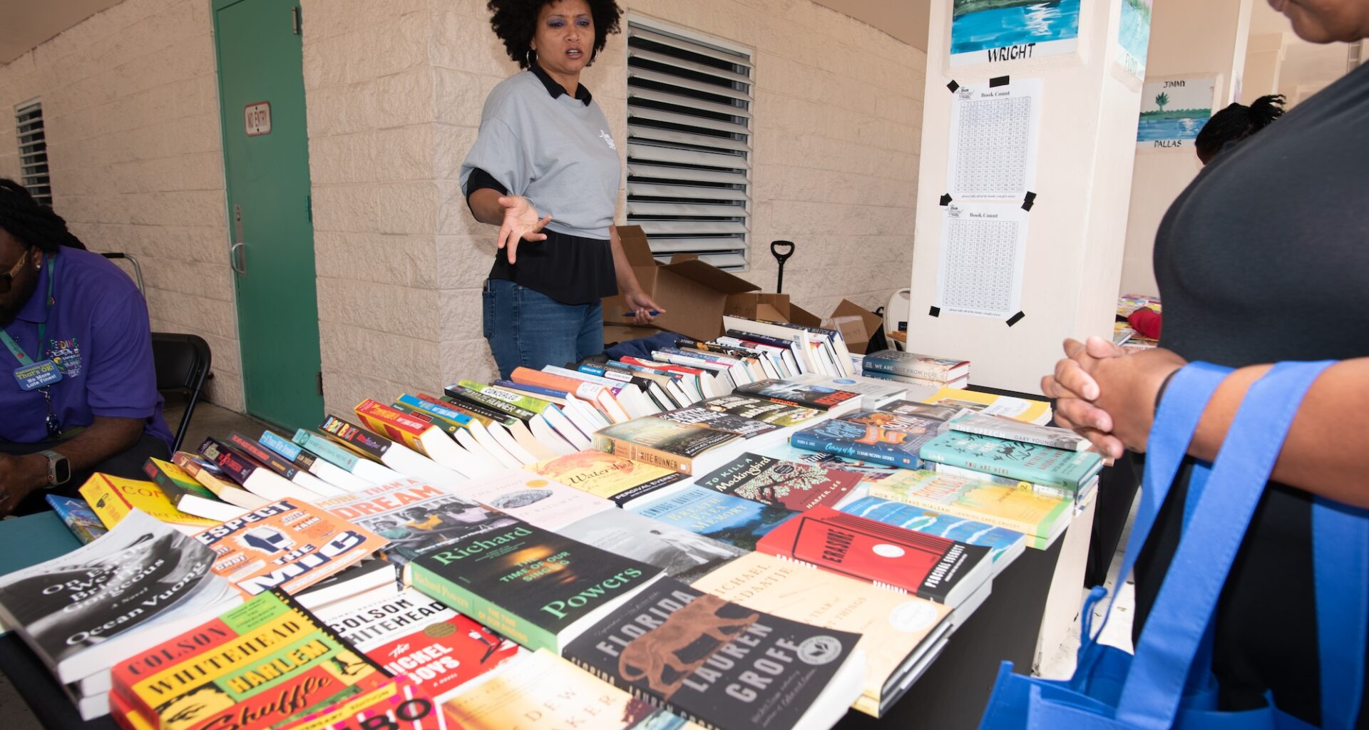 photo of a woman behind a table of books at a book fair