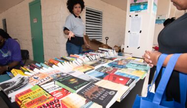 photo of a woman behind a table of books at a book fair