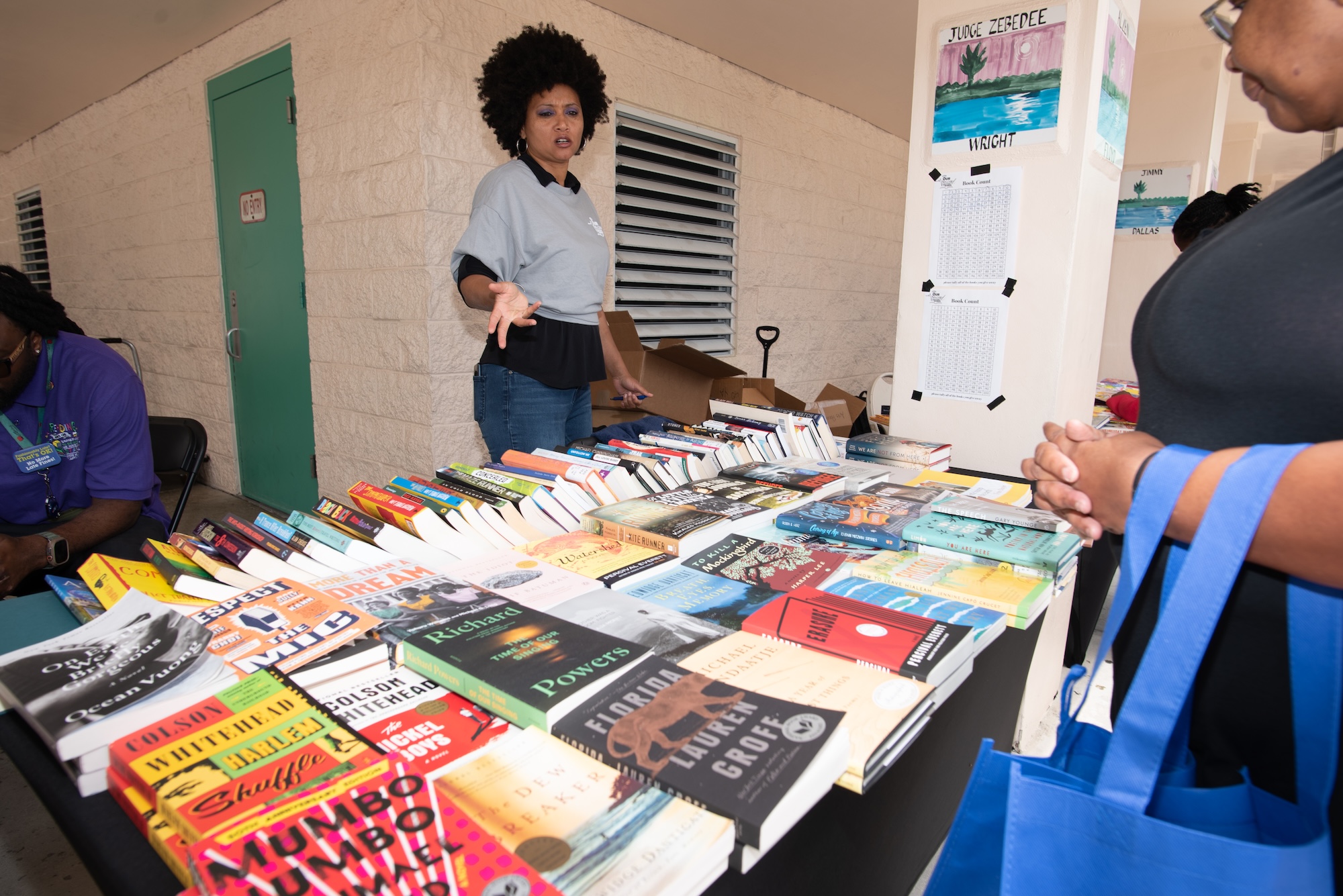 photo of a woman behind a table of books at a book fair