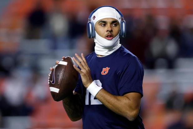 FILE - Auburn quarterback Ashton Daniels warms up before an NCAA college football game against Alabama, Nov. 29, 2025, in Auburn, Ala. (AP Photo/Butch Dill, File)