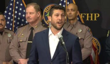 Florida attorney general holding a news conference in Kissimmee
