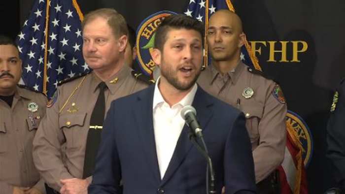 Florida attorney general holding a news conference in Kissimmee