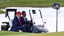 DORAL, FLORIDA - APRIL 03: U.S. President Donald Trump and his son Eric Trump drive in a golf cart after arriving on Marine One on the ninth hole during previews for LIV Golf Miami at Trump National Doral Miami on April 03, 2025 in Doral, Florida. (Photo by Lauren Sopourn/Getty Images)