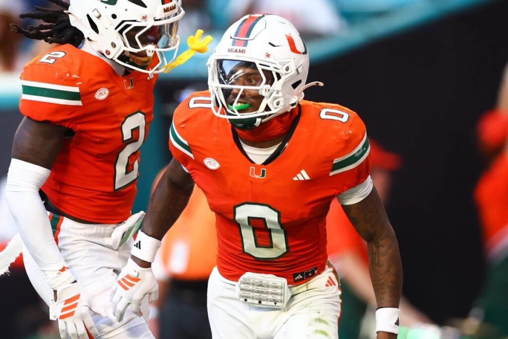 Damari Brown #2 and Keionte Scott #0 of the Miami Hurricanes celebrate a pick six against the Syracuse Orange during the second quarter of the game at Hard Rock Stadium on November 08, 2025 in Miami Gardens, Florida.