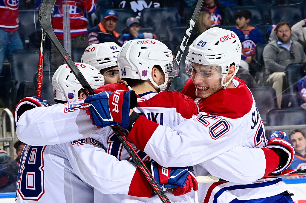 ELMONT, NEW YORK - APRIL 12: Nick Suzuki #14 of the Montreal Canadiens celebrates after scoring his 100th point of the season during the second period against the New York Islanders at UBS Arena on April 12, 2026 in Elmont, New York. (Photo by Steven Ryan/NHLI via Getty Images)