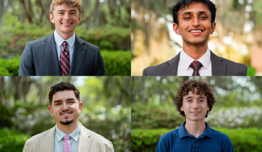 A composite of four individual headshots of young men, arranged in a two-by-two grid. All four are smiling and posed outdoors against a soft-focus background of lush green trees and foliage.