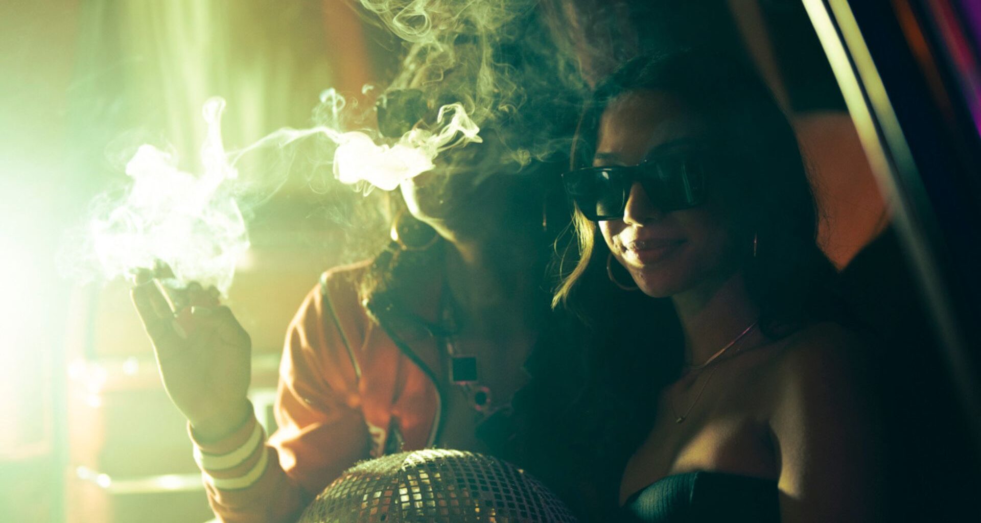 Photo of two young women surrounded by smoke.