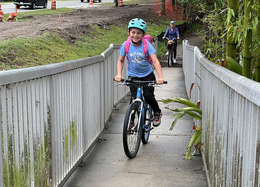 Emmett Thon and any other bikers have to go up the pedestrian bridge one at a time because there is not enough space. The new bridge for the Ward Trail will allow for two golf carts on the trail at a time.