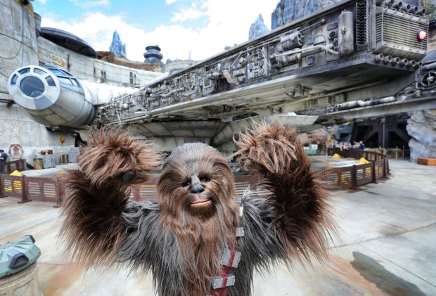 Chewbacca in front of the Millennium Falcon at Black Spire Outpost at the Star Wars: Galaxy's Edge attraction at Disney's Hollywood Studios in Lake Buena Vista. (Joe Burbank/Orlando Sentinel) 