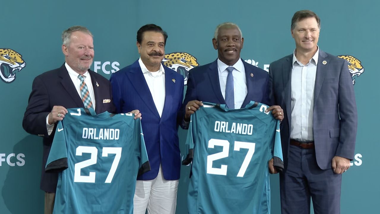 From left to right, Orlando Mayor Buddy Dyer, Jacksonville Jaguars owner Shad Khan, Orange County Mayor Jerry Demings and Florida Citrus Sports CEO Steve Hogan at the official announcement of the Jaguars playing in Orlando. (Spectrum News)