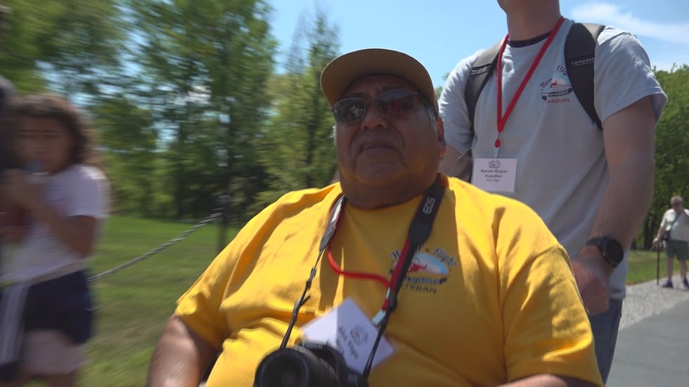 Vietnam Veteran Alex Vega gazes at the black granite of the memorial wall in Washington, D.C..