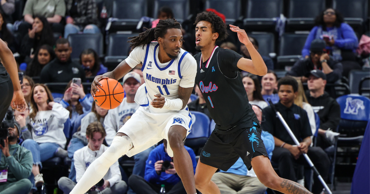 Jan 29, 2026; Memphis, Tennessee, USA; Memphis Tigers forward Aaron Bradshaw (11) drives against Florida Atlantic Owls forward Devin Williams (1) during the second half at FedExForum. Mandatory Credit: Wesley Hale-Imagn Images