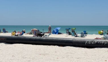 A giant black pipe stretching across Lido Beach is part of a renourishment project, but it is also making things safer for those sailing through the New Pass Channel. (Spectrum News/Claire Alfree)