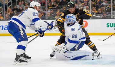 Boston Bruins right wing David Pastrnak (88) gets tangled with Tampa Bay Lightning goaltender Andrei Vasilevskiy (88) during the first period of an NHL hockey game, Saturday, April 11, 2026, in Boston. (AP Photo/Robert F. Bukaty)