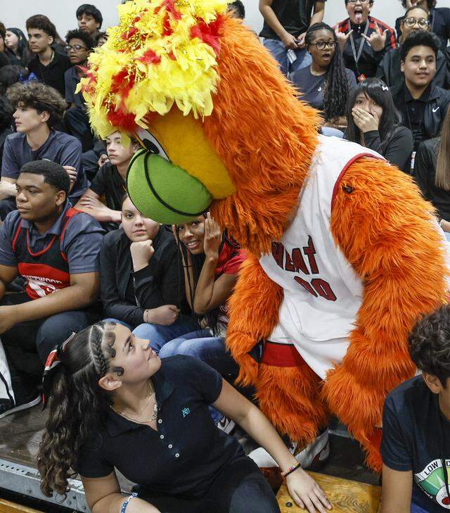 In celebration of Earth Day, the Miami Heat began the day's events with a pep rally as student Mia Maldonado, 14, looks up at Burnie the mascot at Driftwood Middle School in Hollywood, Florida, on Thursday, April 9, 2026. Miami Heat's efforts aim to bolster Driftwood's environmental programs and curriculum, which have already earned the school national and state recognition.