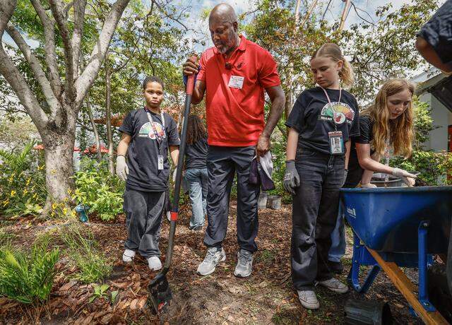 Former NBA player Glen Rice works with students as the school prepares for Earth Day, as the Miami Heat transforms the outdoor area at Driftwood Middle School by installing a new garden and updating the interior. Featuring a butterfly garden, planting beds, and indoor hydroponic towers, students help by planting flowers, vegetables, and greenery, creating a welcoming and peaceful environment in Hollywood, Florida, on Thursday, April 9, 2026. 