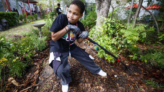 Student Tanner English digs a hole in the garden as the school prepares for Earth Day, as the Miami Heat transforms the outdoor area at Driftwood Middle School by installing a new garden and updating the interior. Featuring a butterfly garden, planting beds, and indoor hydroponic towers, students help by planting flowers, vegetables, and greenery, creating a welcoming and peaceful environment in Hollywood, Florida, on Thursday, April 9, 2026. 