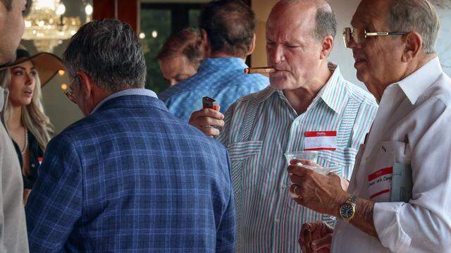 Nick Gutiérrez, center, lights up a cigar as he and other Cuban and Cuban-American entrepreneurs gathered for a private event on Tuesday, March 31, 2026, in Miami, Florida, to organize and pledge to invest in Cuba if there is a change in government.