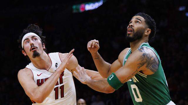 Miami Heat forward Jaime Jaquez Jr. (11) and Boston Celtics forward Jayson Tatum (0) box each other out during the first half of a game on Wednesday, April 1, 2026, at the Kaseya Center in downtown Miami, Fla.