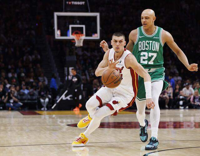 Miami Heat guard Tyler Herro (14) dribbles the ball around Boston Celtics guard Jordan Walsh (27) during the first half of a game on Wednesday, April 1, 2026, at the Kaseya Center in downtown Miami, Fla.