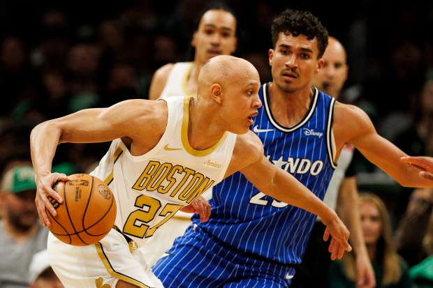 Boston Celtics guard Jordan Walsh left, gets around Orlando Magic forward Tristan da Silva right, during the first half at the TD Garden on April 12, 2026. (CJ Gunther/Boston Herald)