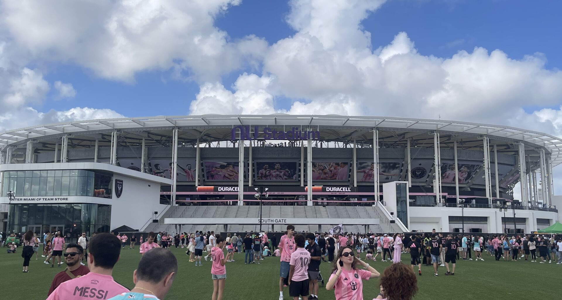 soccer fans walk in front of Miami's new stadium