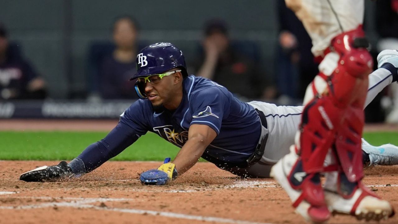 Tampa Bay's Richie Palacios, left, scores in the eighth inning of the Rays' 3-2 win Monday night at Cleveland. (AP Photo/Sue Ogrocki)