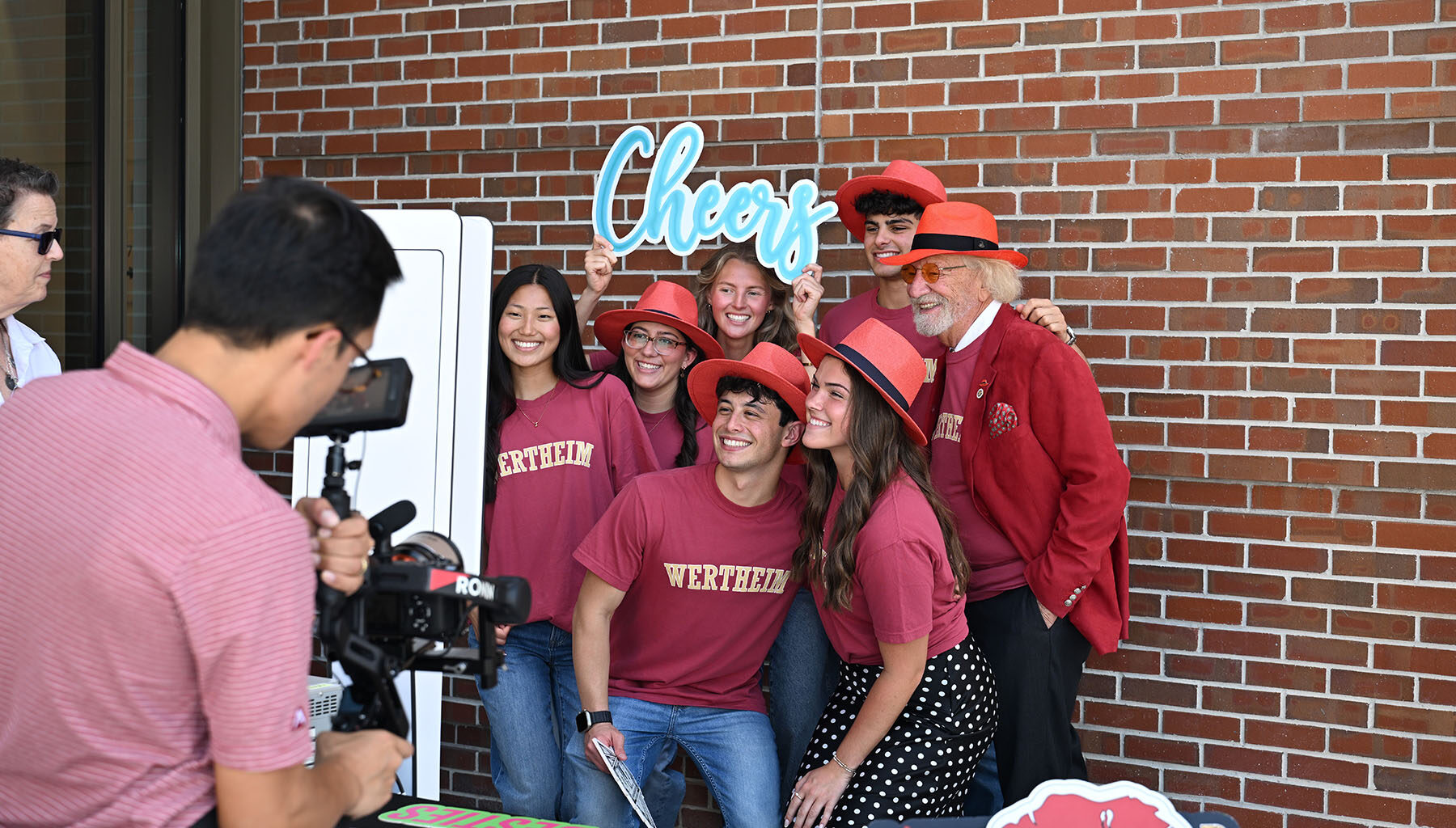 The speakers for Red Hat Day pose in their red hats from left, Wertheim College Dean Michael D. Hartline, Dr. Herbert Wertheim, student Jaclyn Madson and FSU President Richard McCullough.