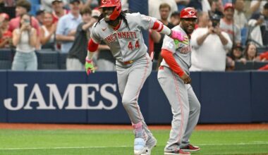 Cincinnati Reds' Elly de la Cruz (44) and third base coach Willie Harris celebrate de la Cruz's two run home run during the first inning of a baseball game against the Tampa Bay Rays Tuesday, April 21, 2026, in St. Petersburg, Fla. (AP Photo/Jason Behnken)