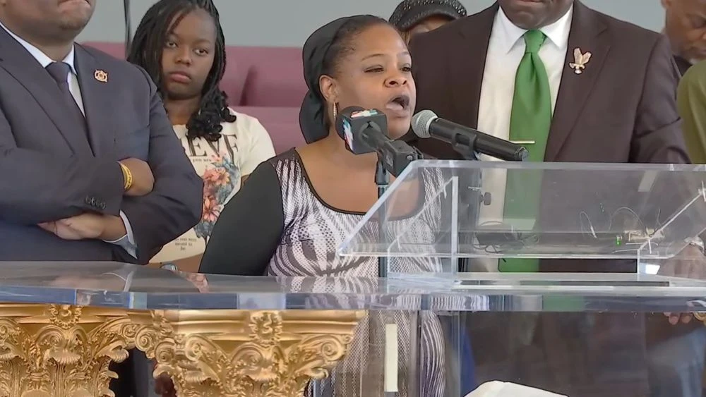 Deonca Gordon at a microphone during a news conference by civil rights attorney Ben Crump.